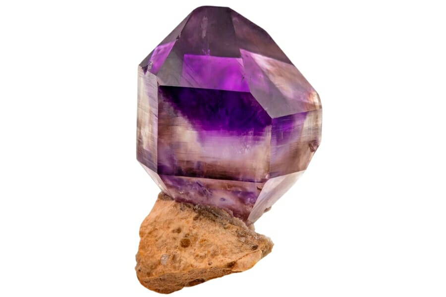 A stunning close up look at an Amethyst crystal displaying deep purple colors inside