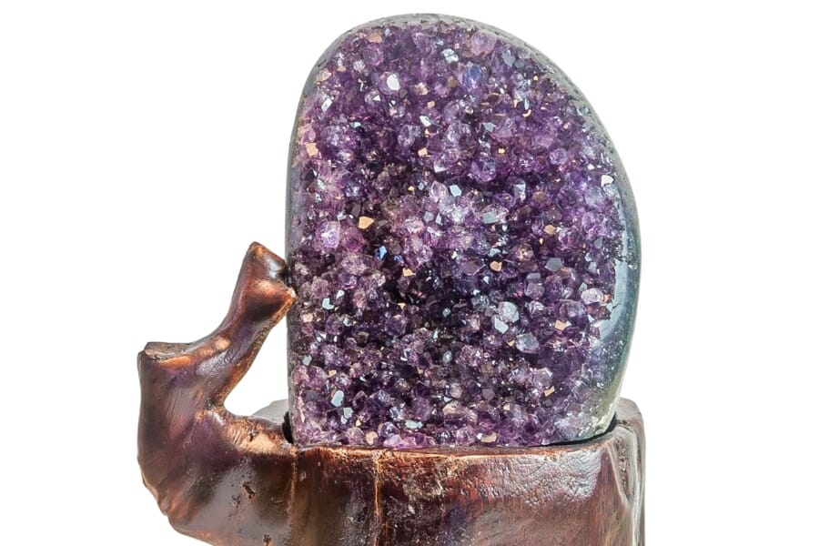 Stunning Amethyst geode with sparkling, purple crystals on a wooden holder