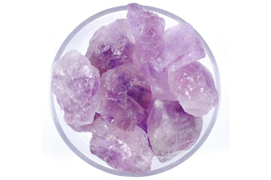 A bunch of lilac-colored Amethyst specimens on a clear, round container
