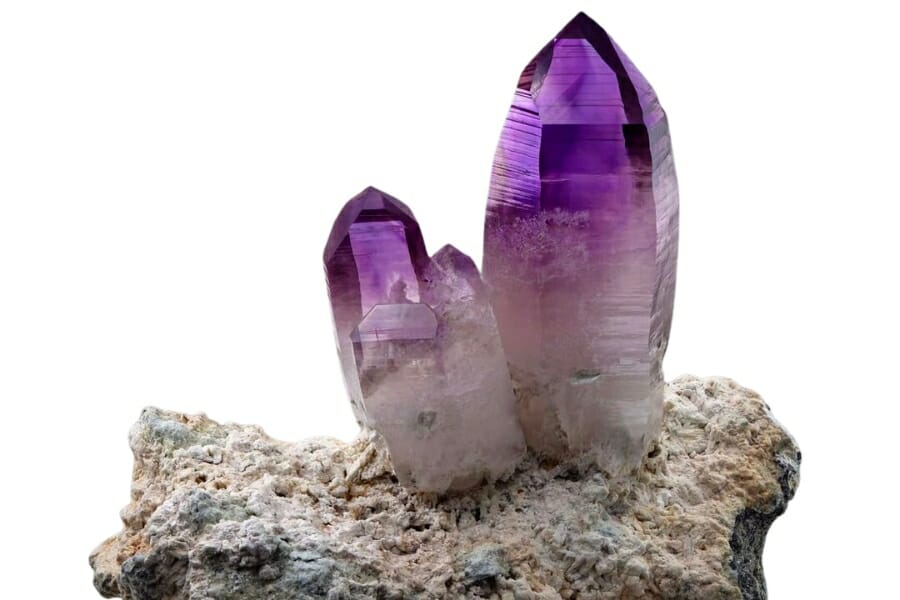 Stunning purple Amethyst crystals protruding from a rock