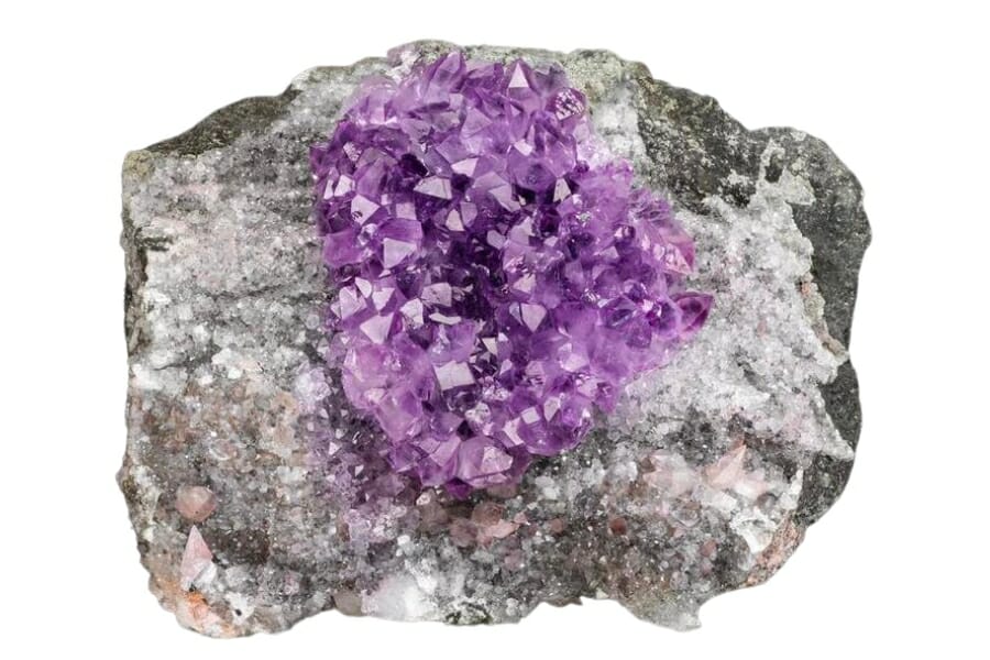 Small, sparkling purple Amethyst crystals attached to a rock