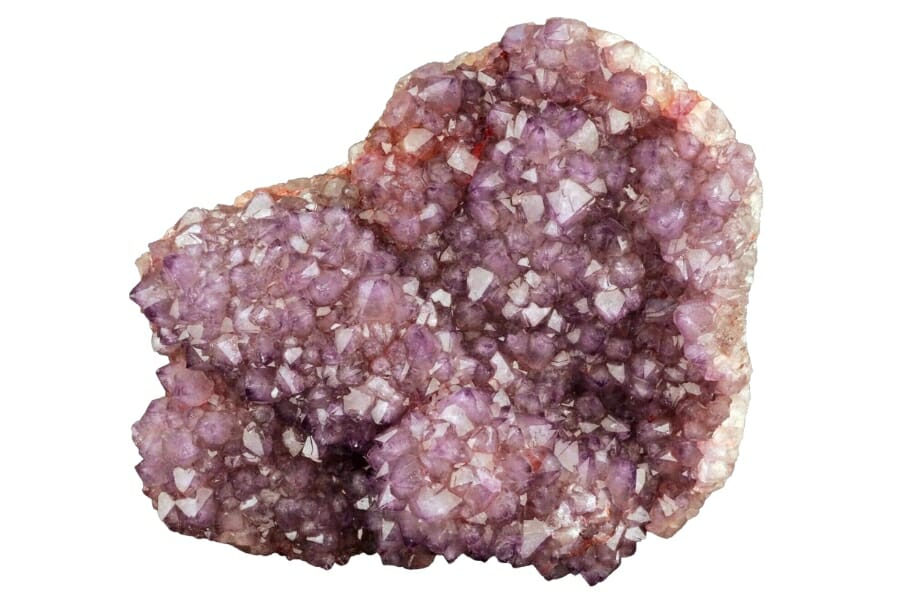 Small, sparkling purple Amethyst crystals inside a geode