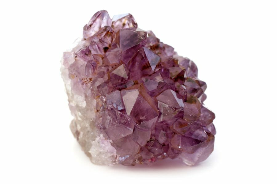 A gorgeous amethyst crystal cluster with white minerals on its side