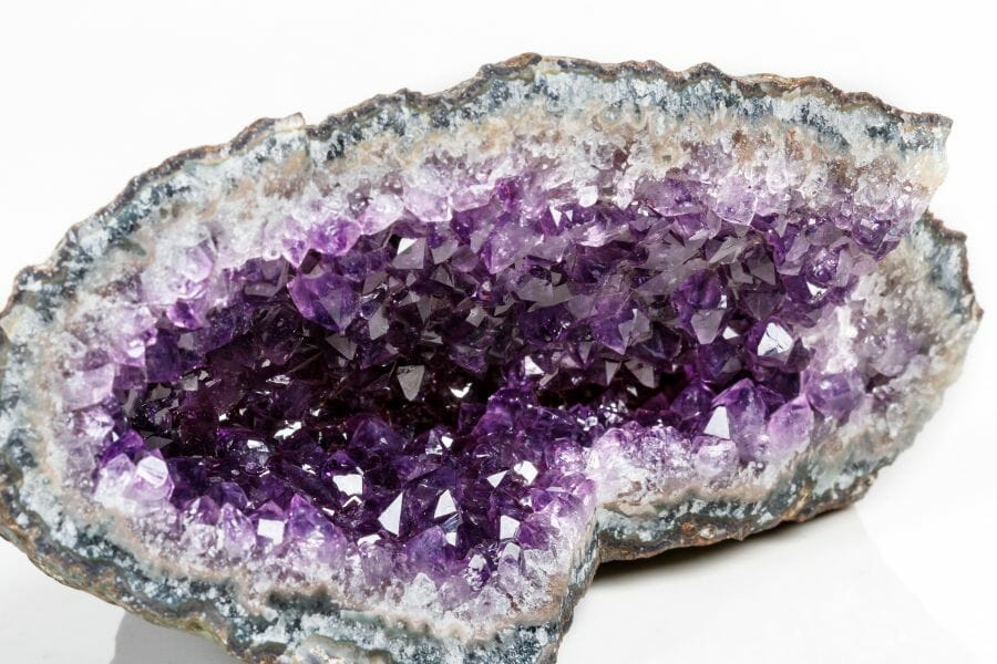 An enormous geode lined with shimmering amethyst and quartz crystals