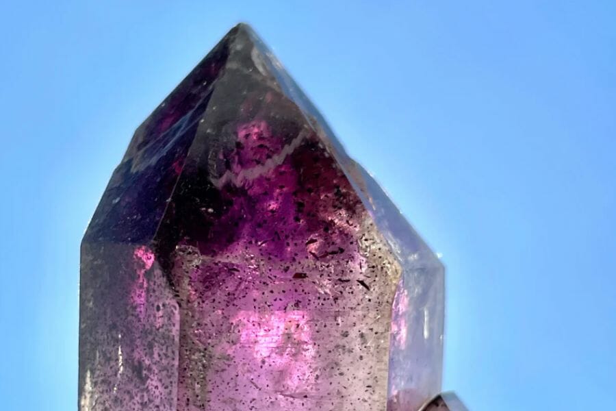 A huge amethyst scepter photographed under the blue sky