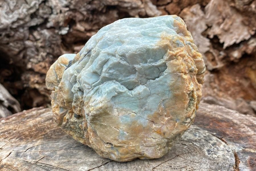 A stunning round-shaped beryl sitting on a log