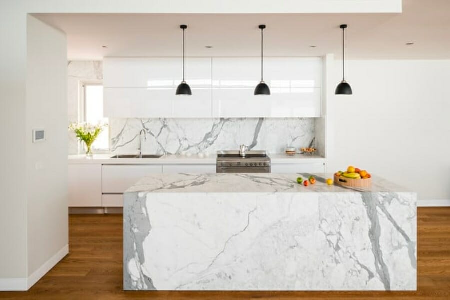 White Calacatta Marble with gray veins used as kitchen countertop and backsplash
