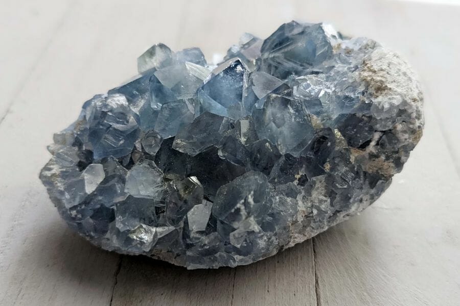 A pretty celestite cluster on a wooden floor