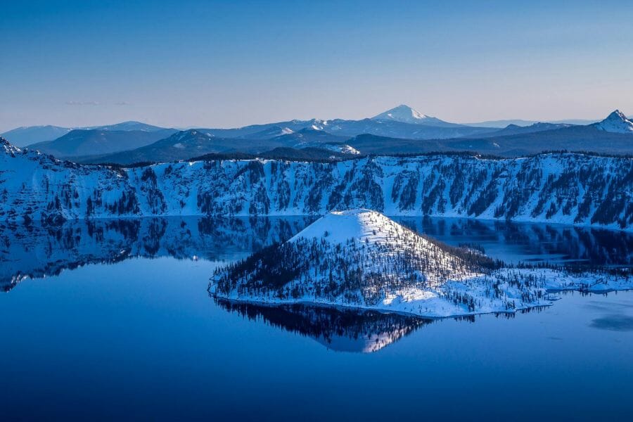 The historical Crate Lake National Park with snowy surroundings and an island at the middle