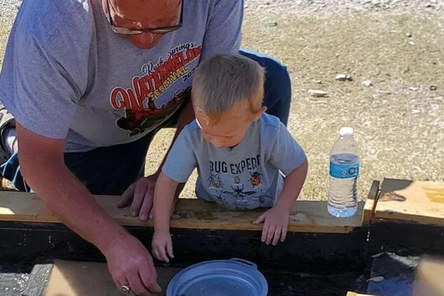 A kid looking for rocks and minerals at the Dark Water Ranch