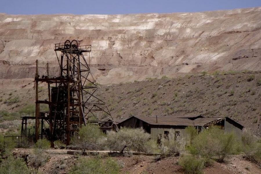 A photo of the old El Tigre Mine with a rock formation in the background