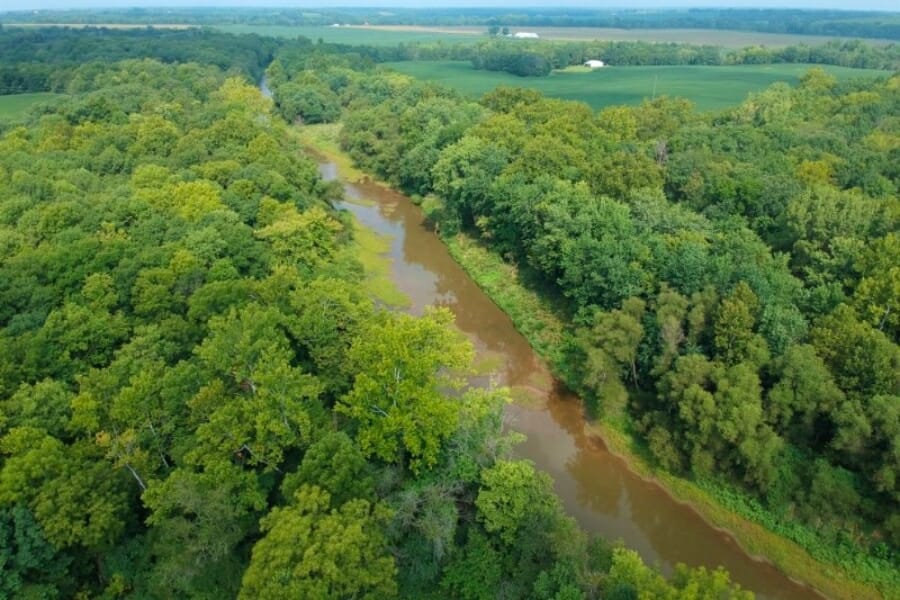 A stunning aerial view of the Fabius River and its surrounding green forest