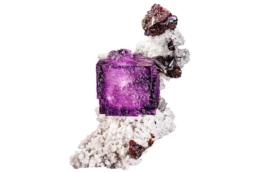 A violet Fluorite crystal on a white Dolomite matrix with crimson Sphalerite 