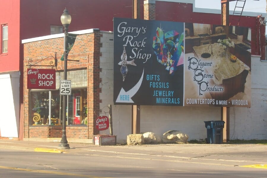 A look at the building of Gary's Rock Shop with a huge advertisement billboard of the shop on the side