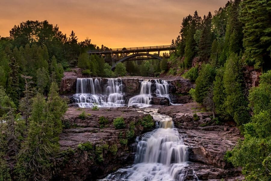 A breathtaking view of the falls under the bridge at Gooseberry Falls State Park