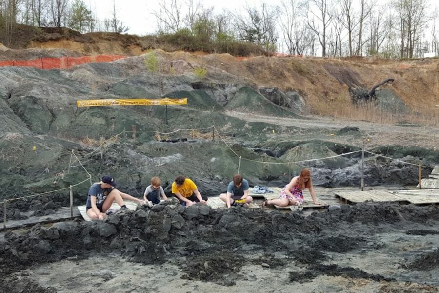 A bunch of kids looking for rocks and minerals at Jean and Ric Edelman Fossil Park