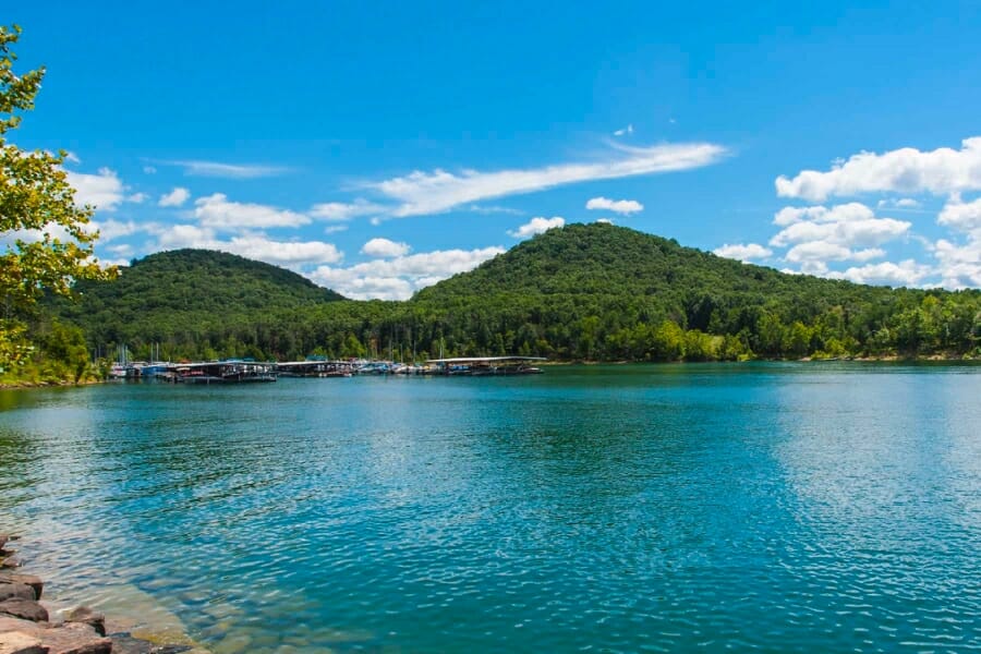 Picturesque view of a sunny Kentucky Lake and its nearby forested landscape