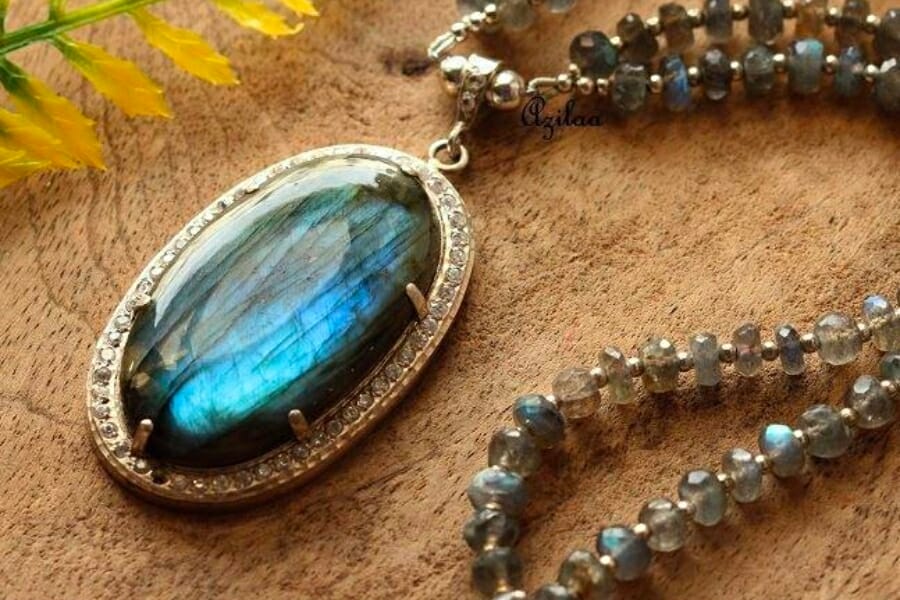 A silver necklace with a pendant adorned with Labradorite in blue hue