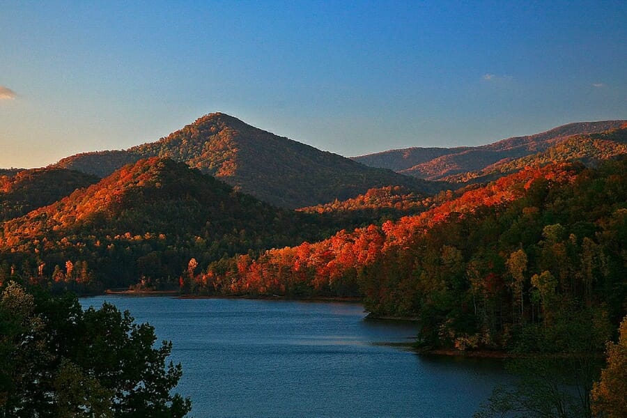 Picturesque view of Lake Chatuge during sunset, showing its surrounding forested mountains