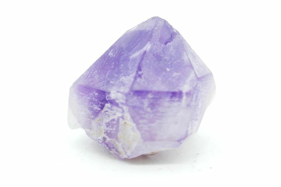 A tiny lavender amethyst crystal with a unique shape