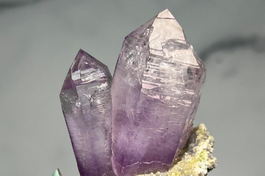 Two crystals towers with pointy ends and a cracked surface