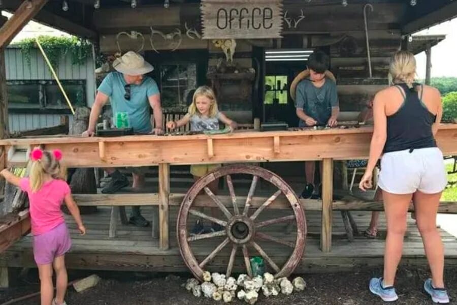 A family busily sifts for gems at the sluice of Little Big Gem Mine & Rock Shop