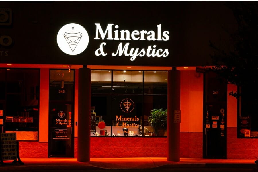 View of the front store window and signage of Minerals & Mystics