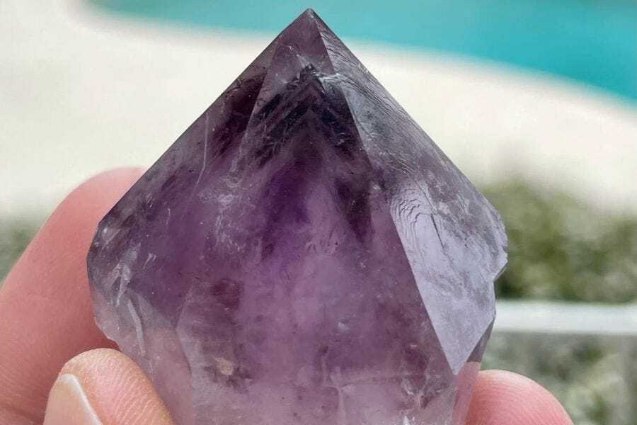 A pointy elegant amethyst crystal with a smooth surface