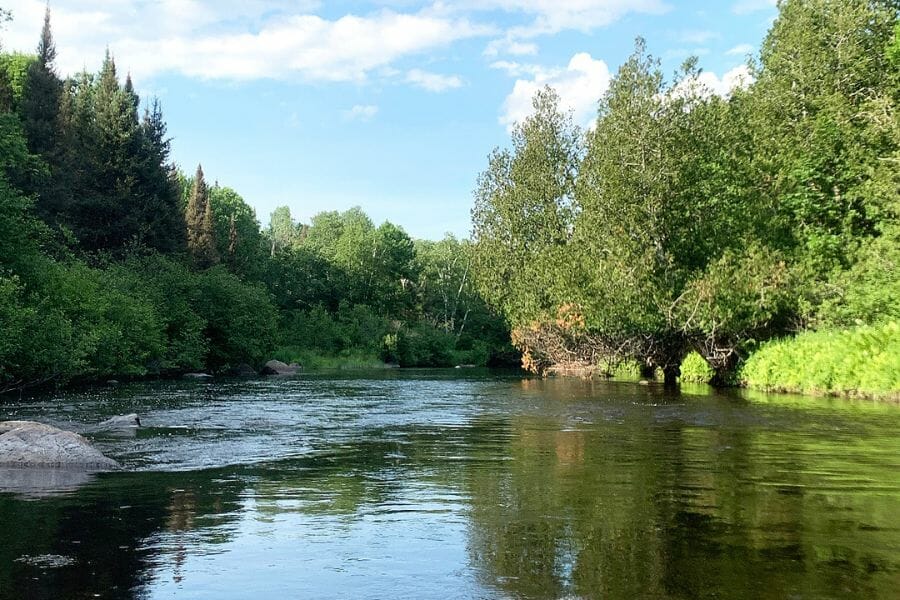 A scenic view of the Pine River Flowage where different minerals are flowing through the water 