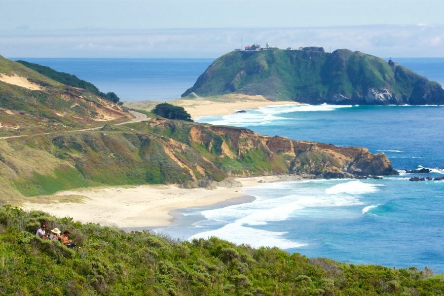 A serene photo of Point Sur with blue waters and lush greens