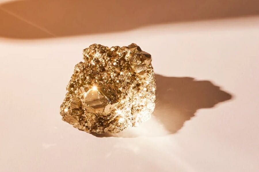 A sparkling rough Pyrite on peach background