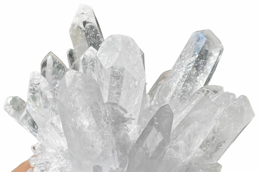 Clear quartz crystal cluster held by a rockhound