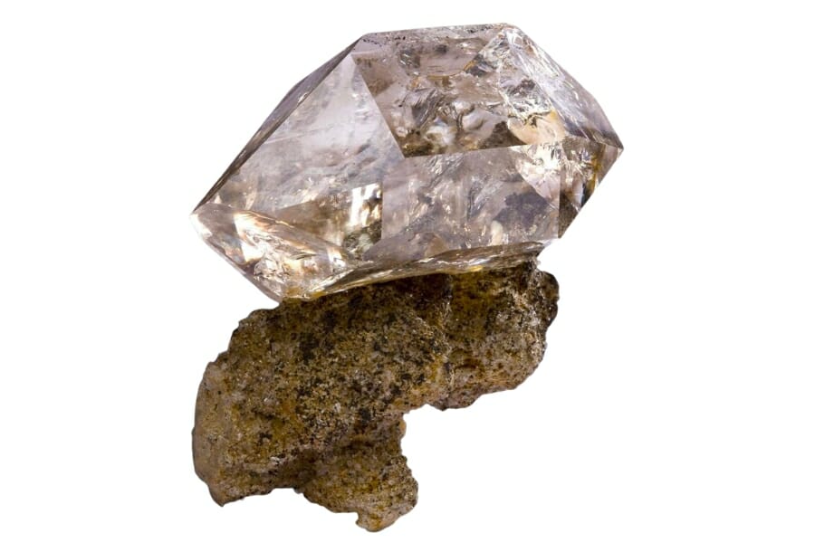 A sparkling Quartz crystal atop a rock