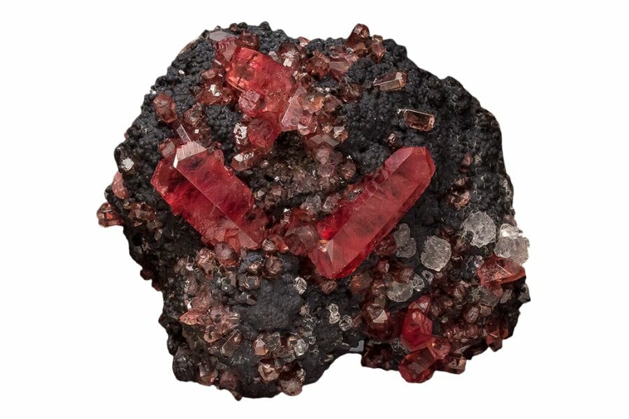 A beautiful rhodochrosite crystal with black and white minerals around it