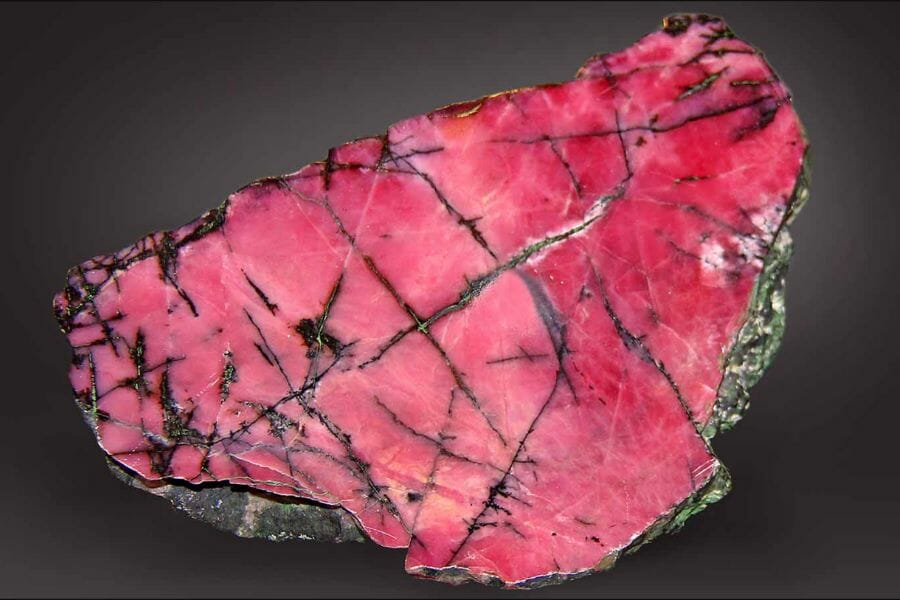 A gorgeous bright pink rhodonite with black streaks found in New Jersey