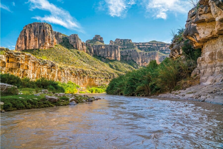 A stunning view of the Rio Grande River and its surrounding might landscapes and rock formations