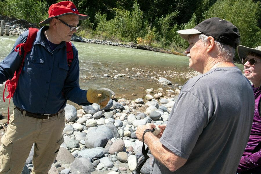 Three rockhounds from a local club along a stream