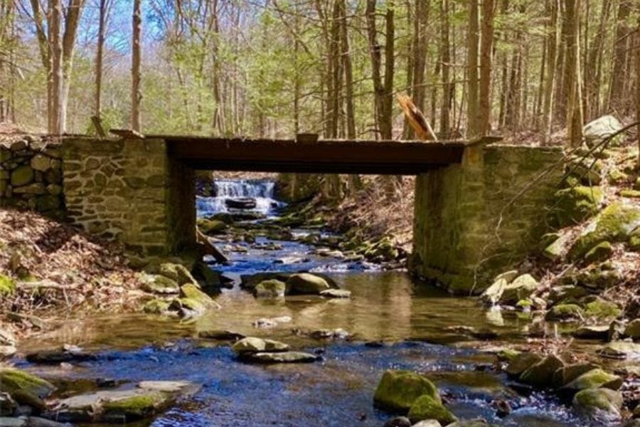 Water flows under the bridge from the Roxbury Falls Mine which contains various minerals