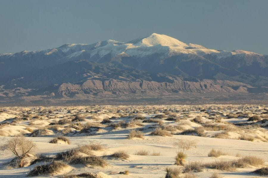 Snowy Sierra Blanca Peaks with sand dunes at the foot of the mountains