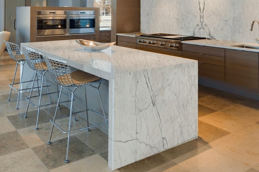 A kitchen countertop made out of grayish white Statuary Marble with light and dark gray and brown veins