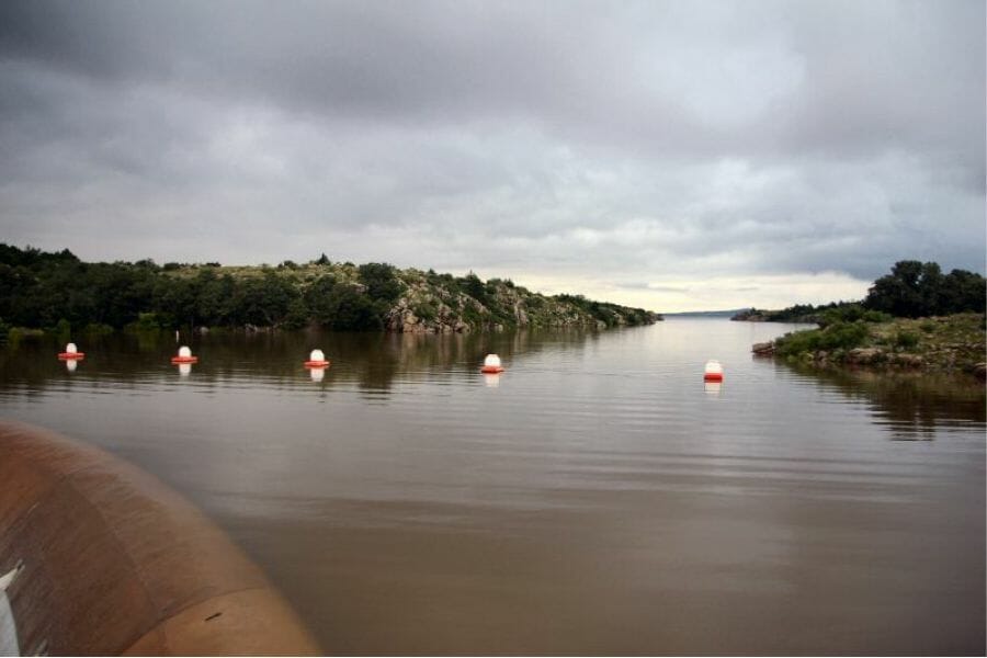 Tom Steed Reservoir with surrounding lands and trees