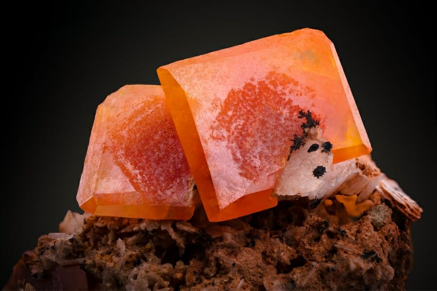 Stunning vibrant orange square crystals of Wulfenite atop a rock