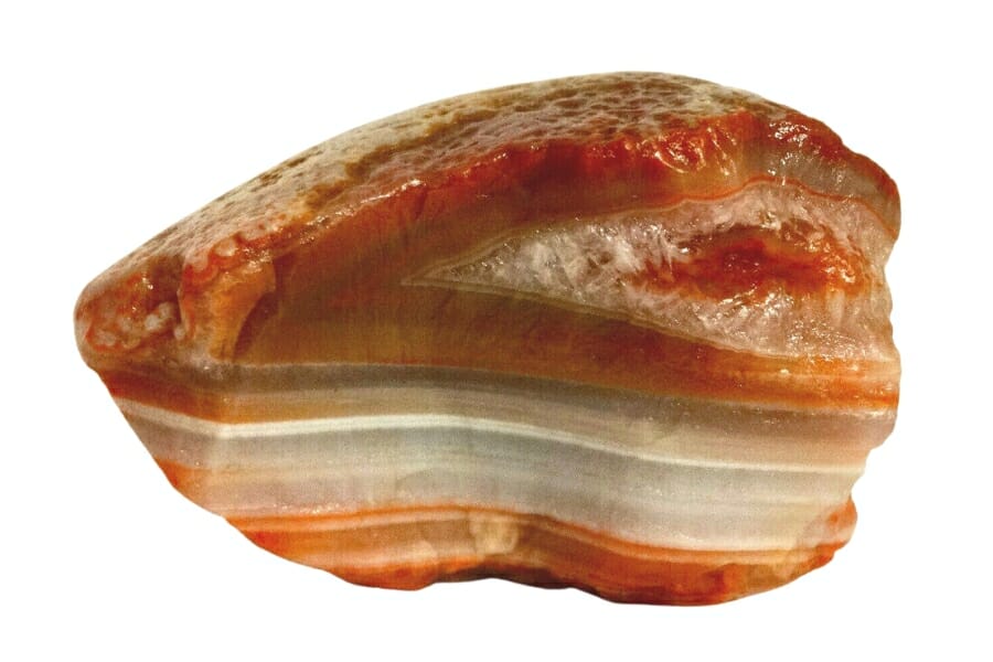 A brilliant agate stone with bright orange colors and a smooth surface