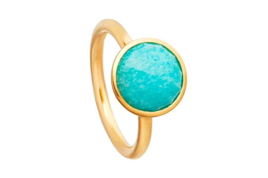A gold ring with a round, bright bluish-green Amazonite set at center stone