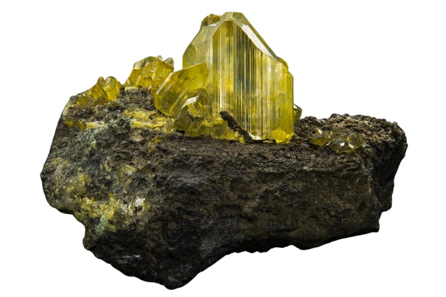 Light yellow Anglesite perched on top of a rock