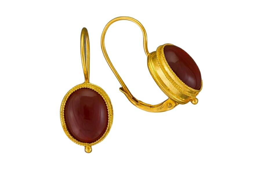 A pair of golden earrings adorned with Brown Carnelians