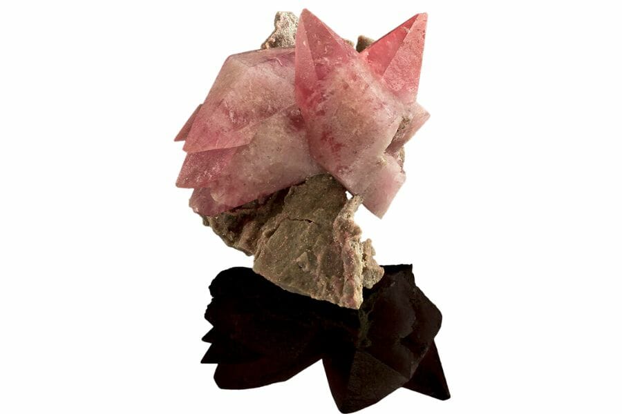 A beautiful pink calcite sitting on another brown mineral
