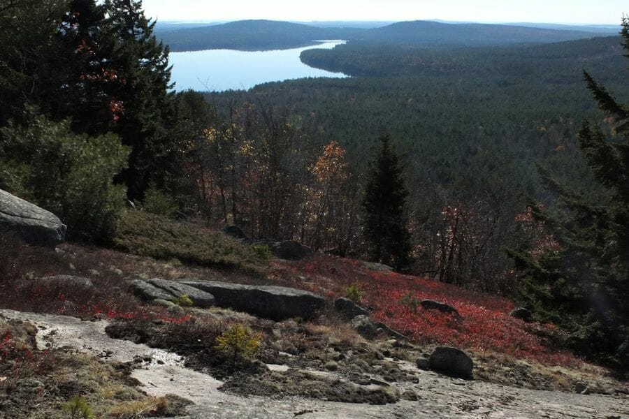 A scenic view from the slops of thw Catherine Mountain with a river flowing at the top right side