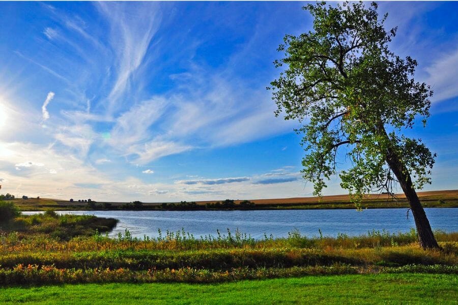 A vibrant and picturesque view of the Cottonwood Lake with tranquil waters and blue skies