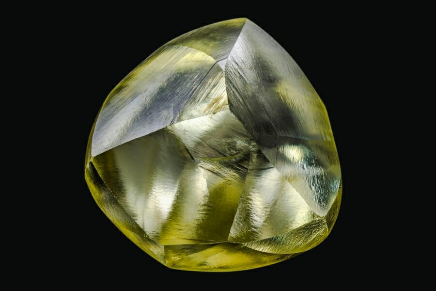 Close up look at a yellow Diamond on black background